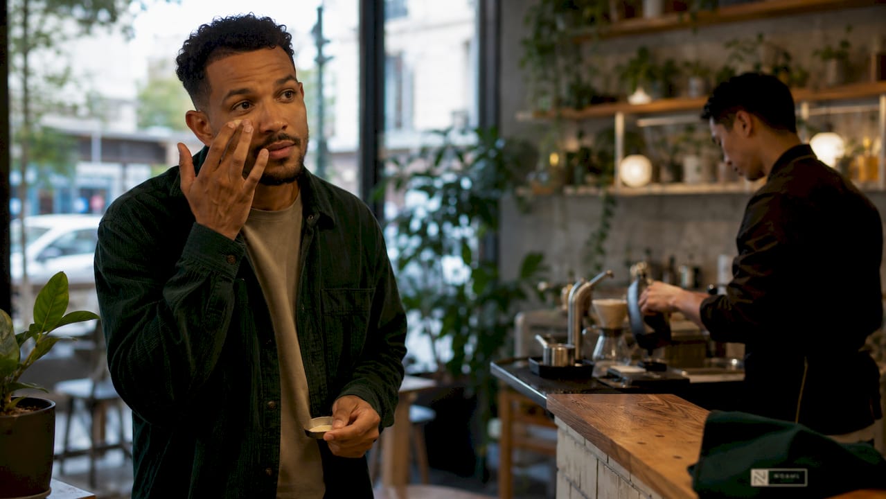 Man applying subtle makeup at vanity