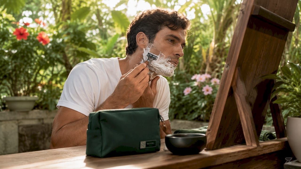 Man shaving in bathroom morning routine