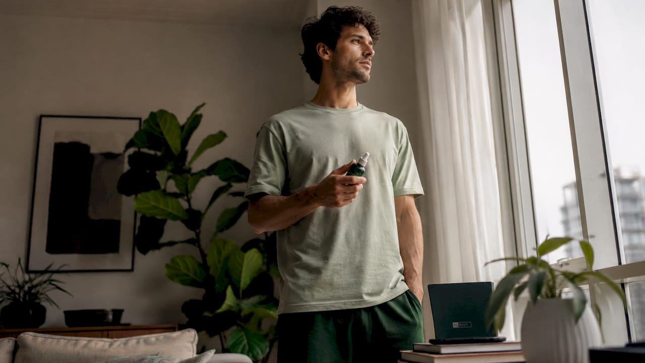 Young man using smartphone with grooming products